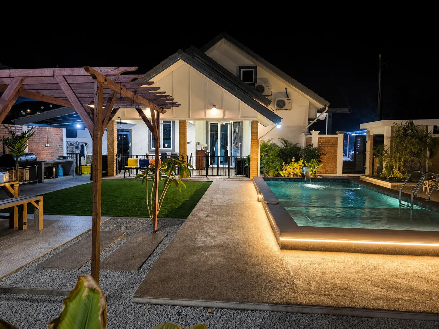 Night front view of Ellamin Courtyard pool and house