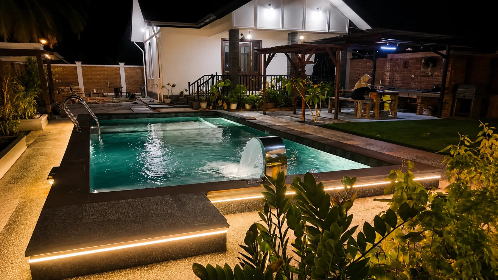 Night view of Ellamin Courtyard private pool with warm lighting